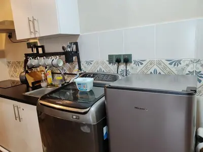 a small kitchen with a stove and a refrigerator at The Anderson Ipoh AA1 Smart TV & 5G WiFi ready in Ipoh