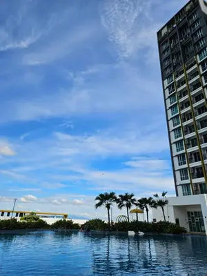 a large swimming pool next to a tall building at New Metropol 3 Bedrooms Pool View in Bukit Mertajam
