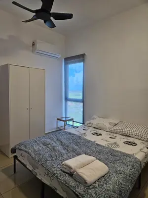 a bedroom with a bed with a ceiling fan at New Metropol 3 Bedrooms Pool View in Bukit Mertajam