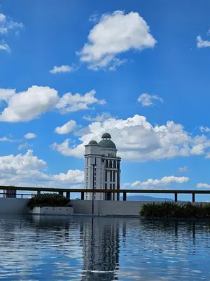 a building sitting on top of a body of water at New Metropol 3 Bedrooms Pool View in Bukit Mertajam