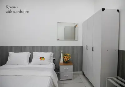 a bedroom with a white bed and a mirror at ICC Suites Ipoh 202A by H2H in Ipoh