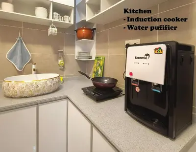 a kitchen counter with a sink and a microwave at ICC Suites Ipoh 202A by H2H in Ipoh