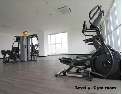 a gym with two treadmills and a treadmill at ICC Suites Ipoh 202A by H2H in Ipoh