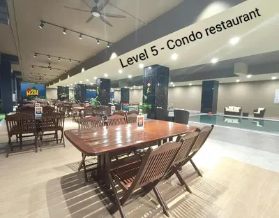a restaurant with a table and chairs in a mall at ICC Suites Ipoh 202A by H2H in Ipoh