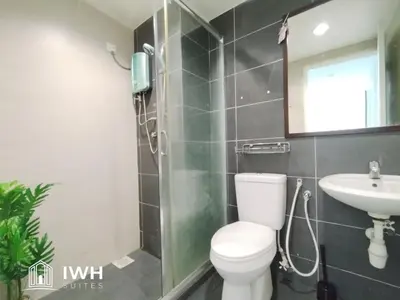 a bathroom with a toilet and a sink at Kinta River Town Suites By IWH in Ipoh