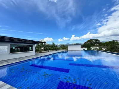 a large swimming pool with blue tiles on a building at Kinta River Town Suites By IWH in Ipoh