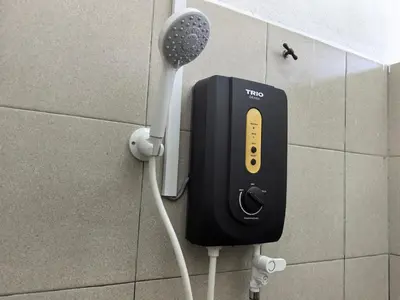a phone on a wall in a bathroom at Suite Karangan Near Inokom in Titi Karangan