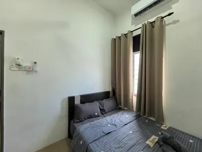 a bedroom with a bed and a window at Suite Karangan Near Inokom in Titi Karangan