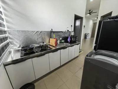 a kitchen with a counter with a sink and a stove at Suite Karangan Near Inokom in Titi Karangan