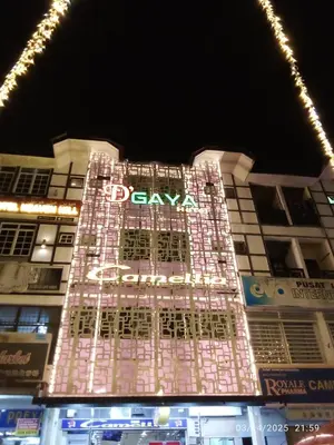 a tall building with a lit up sign on it at D GAYA HOTEL Cameron Highlands in Tanah Rata