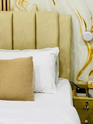 a bedroom with a white bed with a large headboard at Jac Urban Suites Luxury & Premium Staycation 10pax in George Town