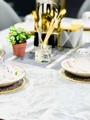 a white table with plates and flowers on it at Jac Urban Suites Luxury & Premium Staycation 10pax in George Town