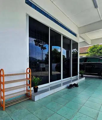 a building with large glass windows on the side of it at Venice Manjung, Lumut by TZ Homestay in Lumut