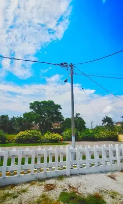 a white fence with a pole next to a street at Venice Manjung, Lumut by TZ Homestay in Lumut