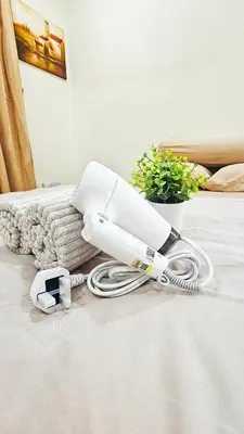 a white hair dryer sitting on top of a floor at Venice Manjung, Lumut by TZ Homestay in Lumut