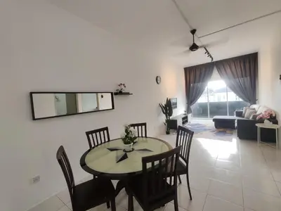 a dining room and living room with a table and chairs at ZE VI Homestay,Tanah Rata in Tanah Rata