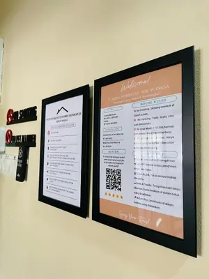 two menus are hanging on a wall at Utaqha Ventures Homestay in Seri Manjung