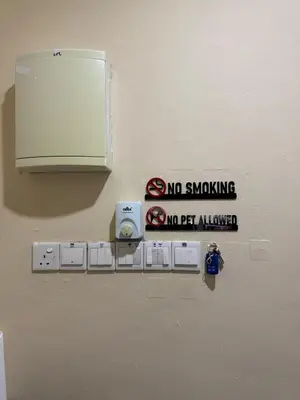 a no smoking sign on a wall with a no smoking sign at Utaqha Ventures Homestay in Seri Manjung