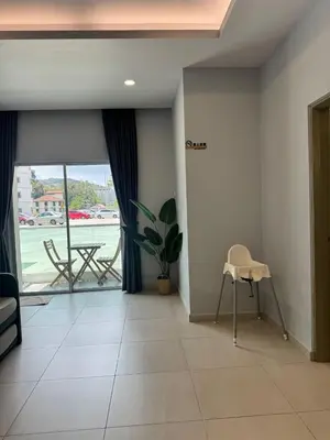 a living room with a table and a chair at AYAAN GAMING HOME at Quintet Play Free GranTurismo in Tanah Rata