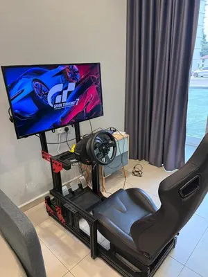 a gaming chair with a television on a stand at AYAAN GAMING HOME at Quintet Play Free GranTurismo in Tanah Rata