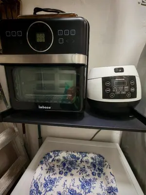 a microwave and a toaster oven on a shelf at Arrisa Guest House d'Anderson Ipoh Perak in Kampong Kepayang