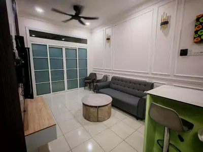a living room with a couch and a table at Arrisa Guest House d'Anderson Ipoh Perak in Kampong Kepayang