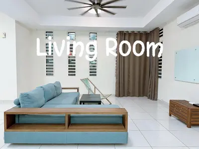 a living room with a blue couch and aanye room sign at 365 Homestay in Kampong Lima Kongsi