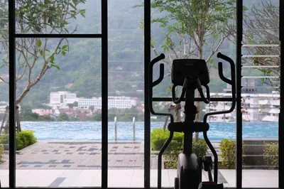a bike parked next to a window with a view of the water at Sunshine Residence Kekloksi View 2R 4pax in Ayer Itam