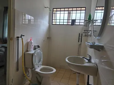 a bathroom with a toilet and a sink at Permata Atiey Homestay in Seri Iskandar