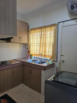 a small kitchen with a sink and a window at Permata Atiey Homestay in Seri Iskandar
