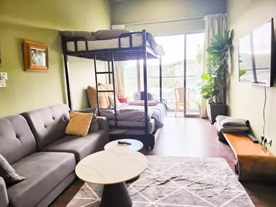 a living room with a couch and a bunk bed at Mossy Forest Family Retreat V, Kea Farm, 2-8 guests, Keafarm, Cameron Highlands in Cameron Highlands