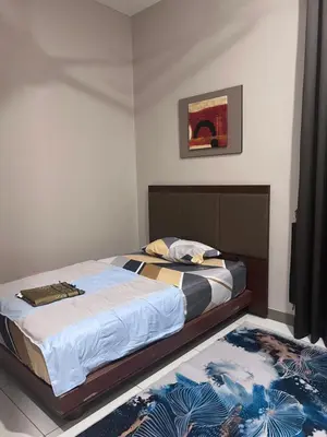 a bedroom with a bed and a rug at Lunas Indah Homestay in Lunas