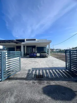 a house with two cars parked in the driveway at Lunas Indah Homestay in Lunas