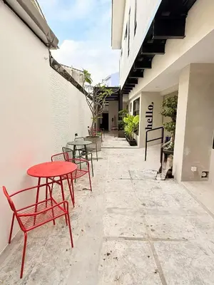 a patio with tables and chairs in a building at TwinTree Kelawai in George Town