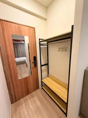 a walk in closet with a wooden door and hangers at TwinTree Kelawai in George Town