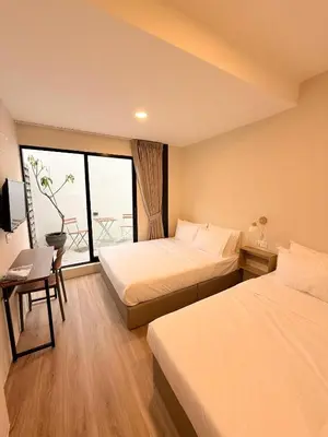 a hotel room with two beds and a window at TwinTree Kelawai in George Town