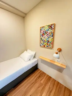 a bedroom with a bed and a painting on the wall at TwinTree Kelawai in George Town