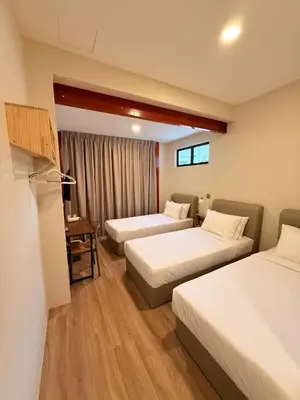 a hotel room with two beds and a table at TwinTree Kelawai in George Town