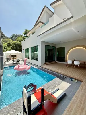 a house with a pool with a pink inflatable pool noodle at LYL EvenHill Private Pool-18-23pax 5BR in Ipoh
