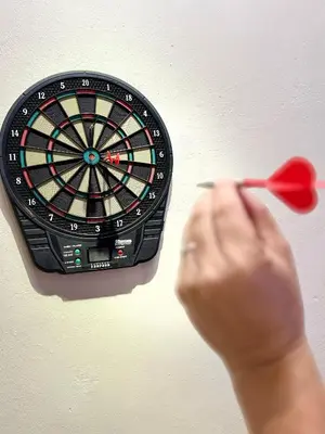 a person holding a dart in front of a dartboard at LYL EvenHill Private Pool-18-23pax 5BR in Ipoh