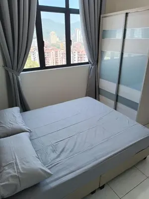 a bed in a room with a large window at The Sun condo at taman sri nibong ,near queenbaymall in Bayan Lepas
