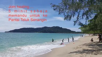 a group of people on a beach near the water at COZY Residence Homestay Teluk Senangin Lumut in Lumut