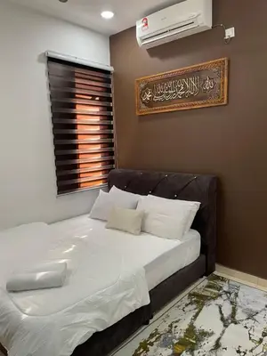 a bedroom with a bed with a air conditioner on the wall at COZY Residence Homestay Teluk Senangin Lumut in Lumut