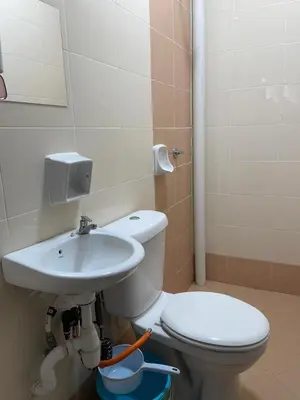 a bathroom with a toilet and a sink at COZY Residence Homestay Teluk Senangin Lumut in Lumut