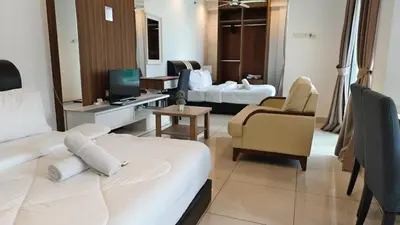a hotel room with two beds and a living room at High-Rise Suite with view-Near Gurney & Gleneagles in George Town