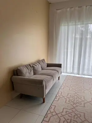 a couch in a living room with a window at Lily Dante in Tanah Rata