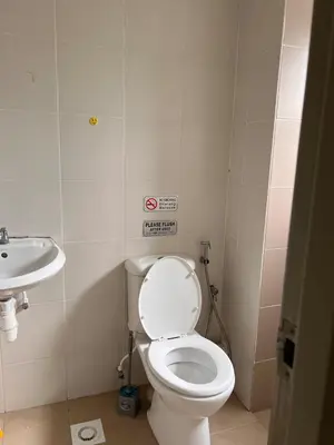 a bathroom with a toilet and a sink at Lily Dante in Tanah Rata