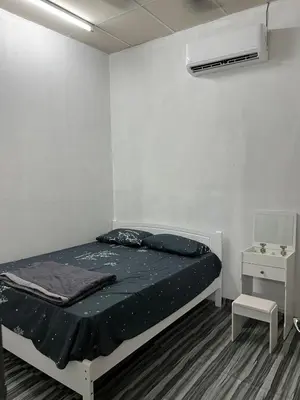 a small bedroom with a bed and a night stand at CK Homestay Parit Buntar Perak in Bagan Serai
