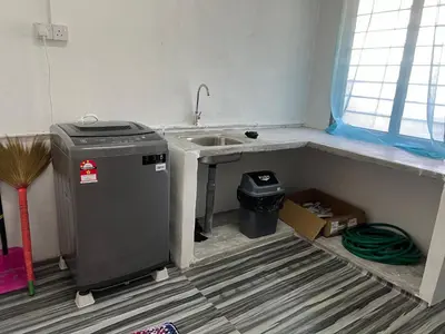 a small kitchen with a sink and a sink at CK Homestay Parit Buntar Perak in Bagan Serai