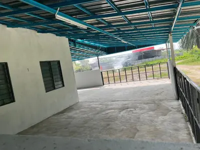 an empty building with a train in the background at CK Homestay Parit Buntar Perak in Bagan Serai
